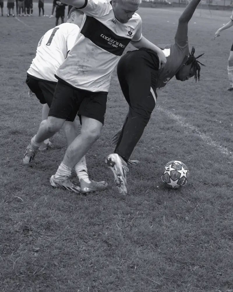 Two players challenge for the ball on the line at the 2024 tournament