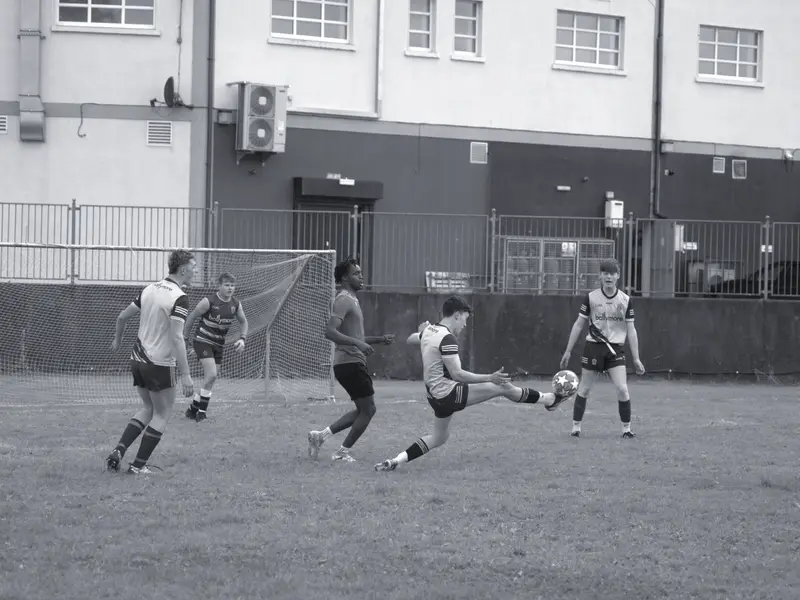 A defender clears under pressure at the 2024 tournament